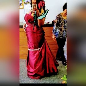 A Indian Garnet Red Mermaid Bridal Symphony Wedding Gown with pick up Trail.